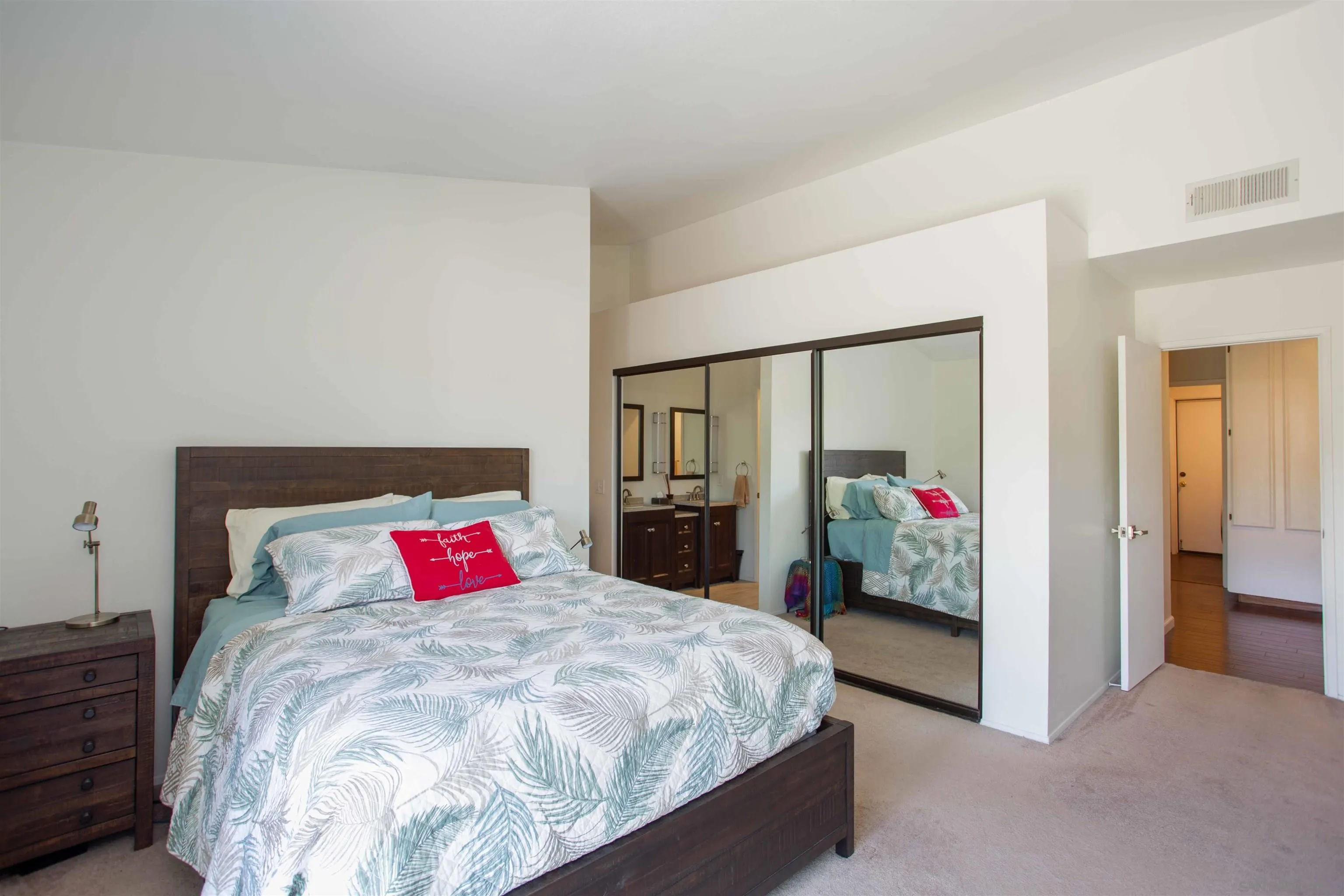 9182 Emden Road San Diego, CA 92129 - Photo 19 of 27 a bed sitting in a bedroom next to a lamp