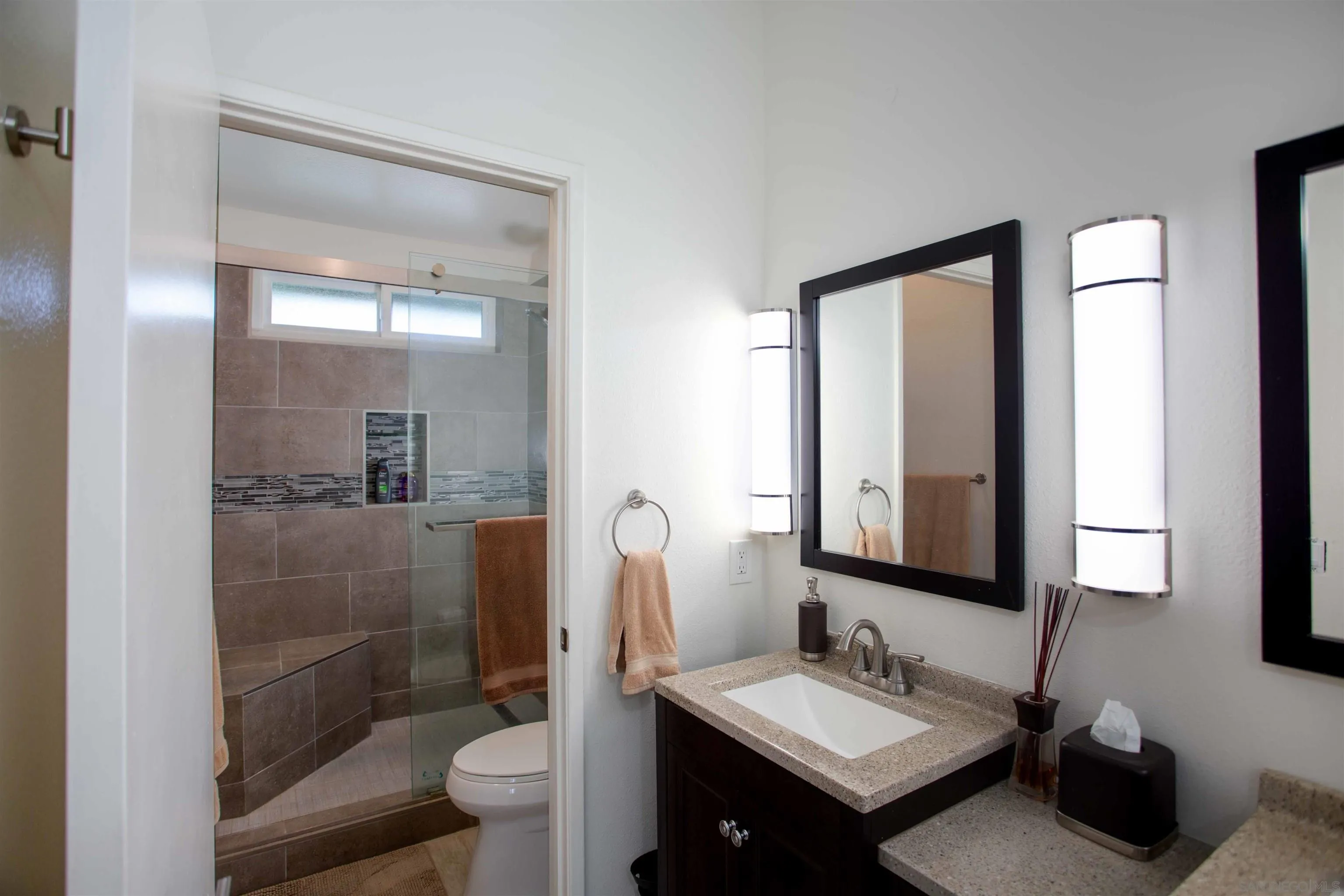 9182 Emden Road San Diego, CA 92129 - Photo 20 of 27 a bathroom with a sink a toilet and shower a mirror