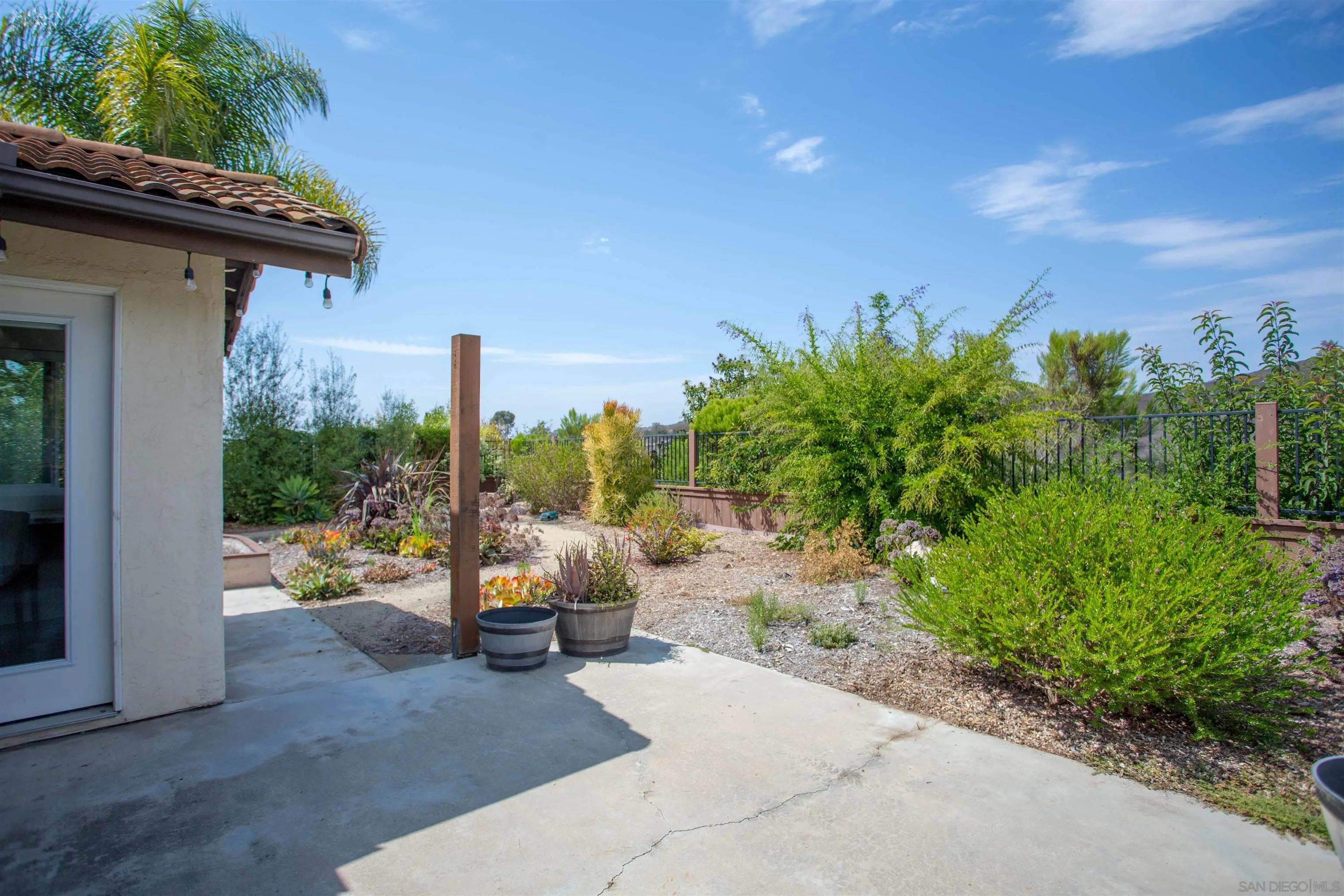 9182 Emden Road San Diego, CA 92129 - Photo 26 of 27 a view of a patio with couple of chairs and potted plants