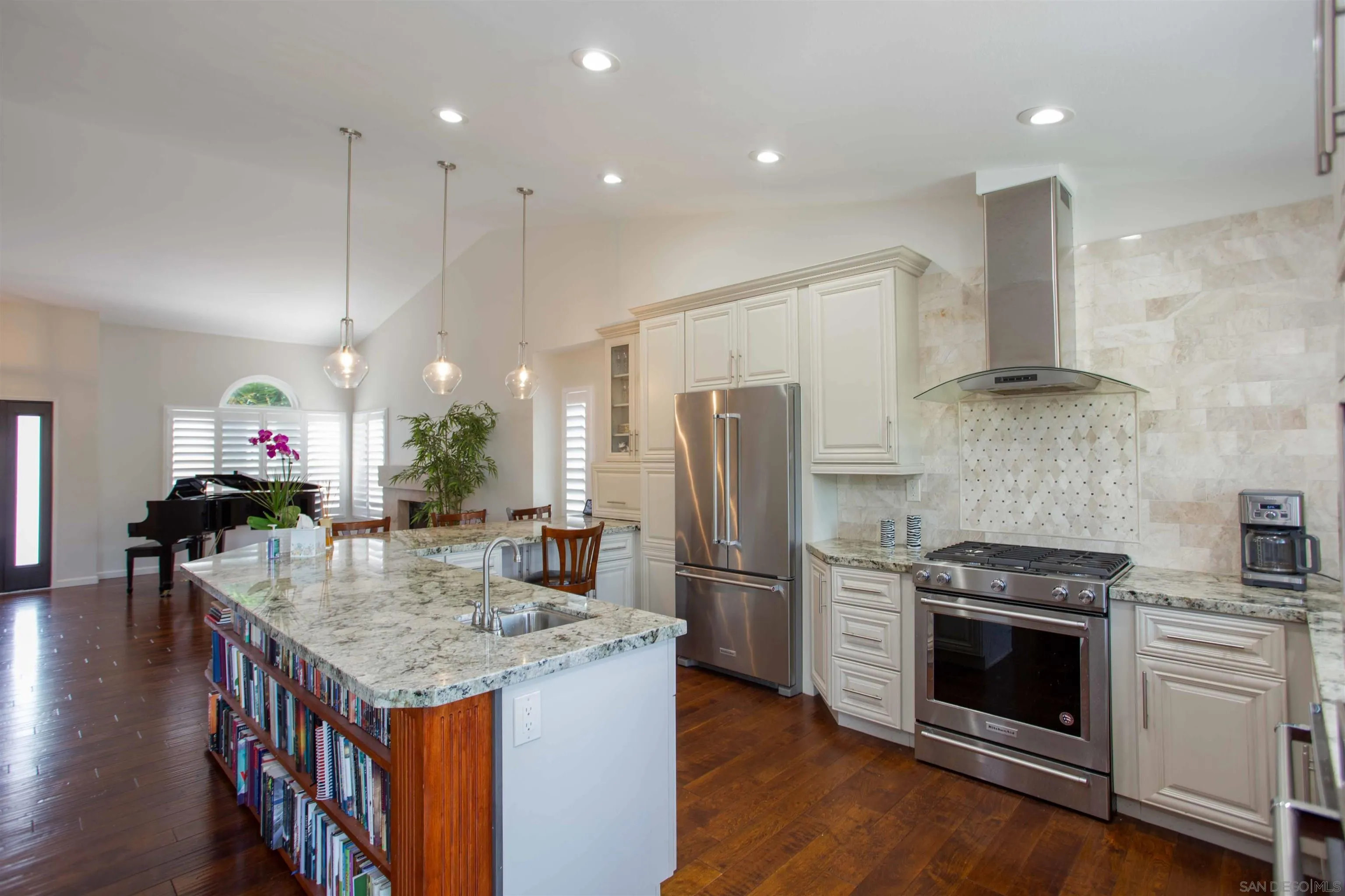 9182 Emden Road San Diego, CA 92129 - Photo 7 of 27 a kitchen with granite countertop kitchen island wooden floor center island stainless steel appliances and cabinets