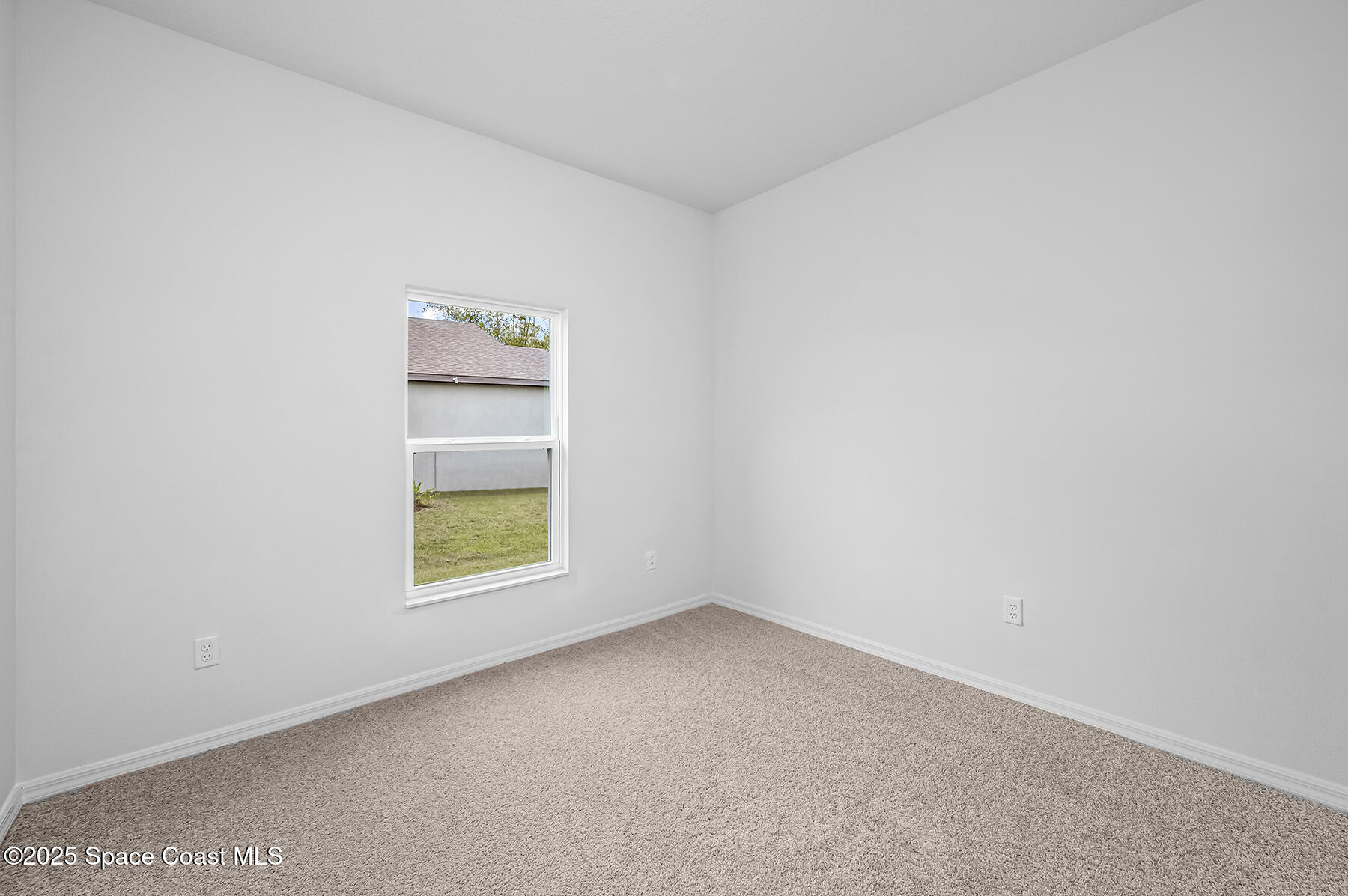 435 Olney Street Palm Bay, FL 32908 - Photo 16 of 18 an empty room with a window