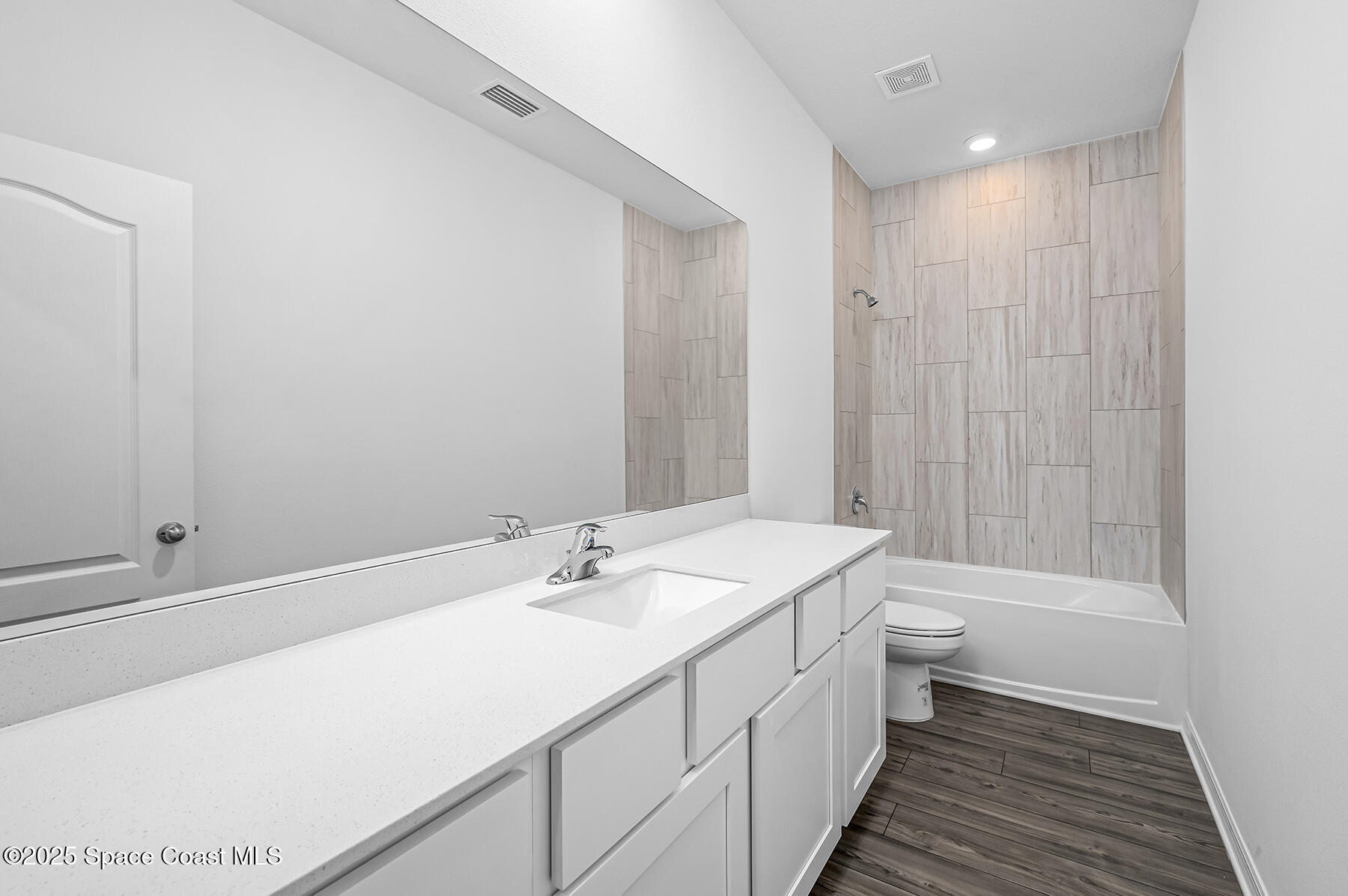 435 Olney Street Palm Bay, FL 32908 - Photo 17 of 18 a bathroom with a double vanity sink toilet and shower