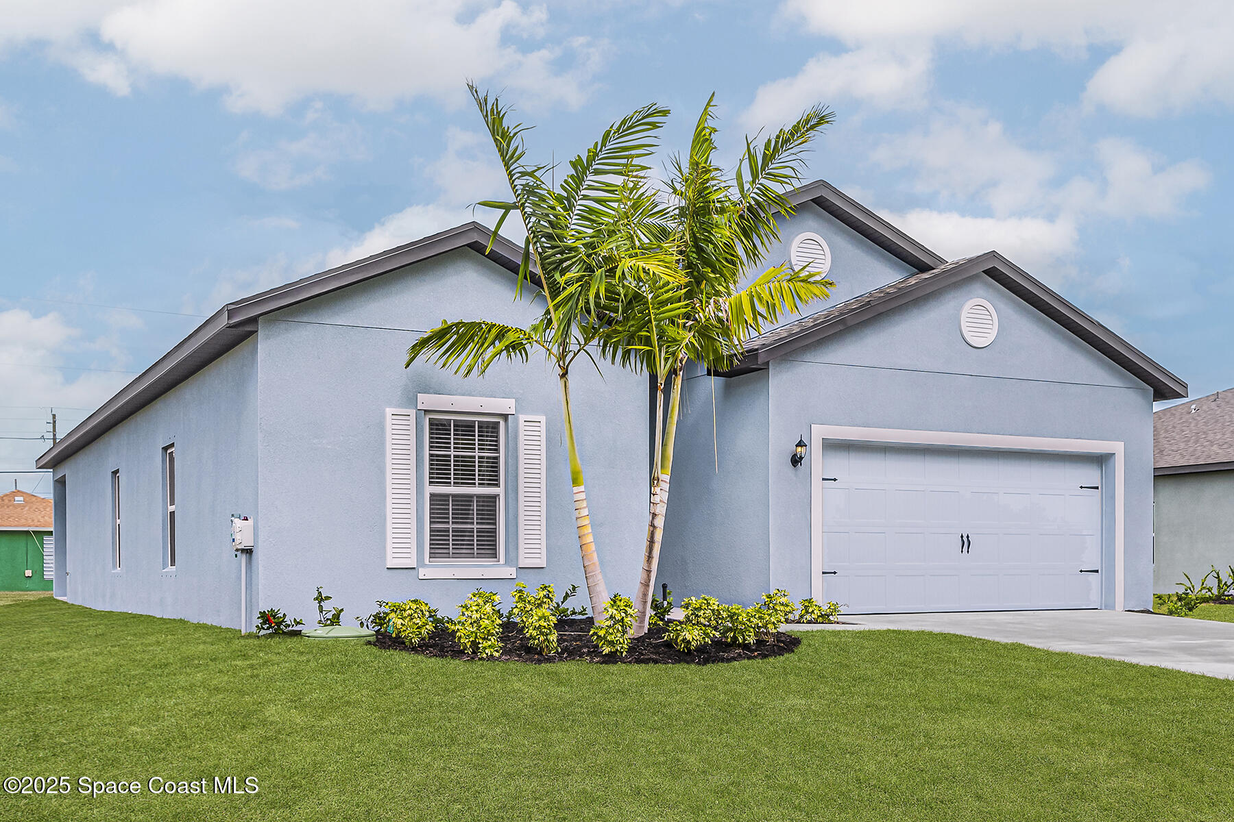 435 Olney Street Palm Bay, FL 32908 - Photo 2 of 18 a front view of a house with a garden