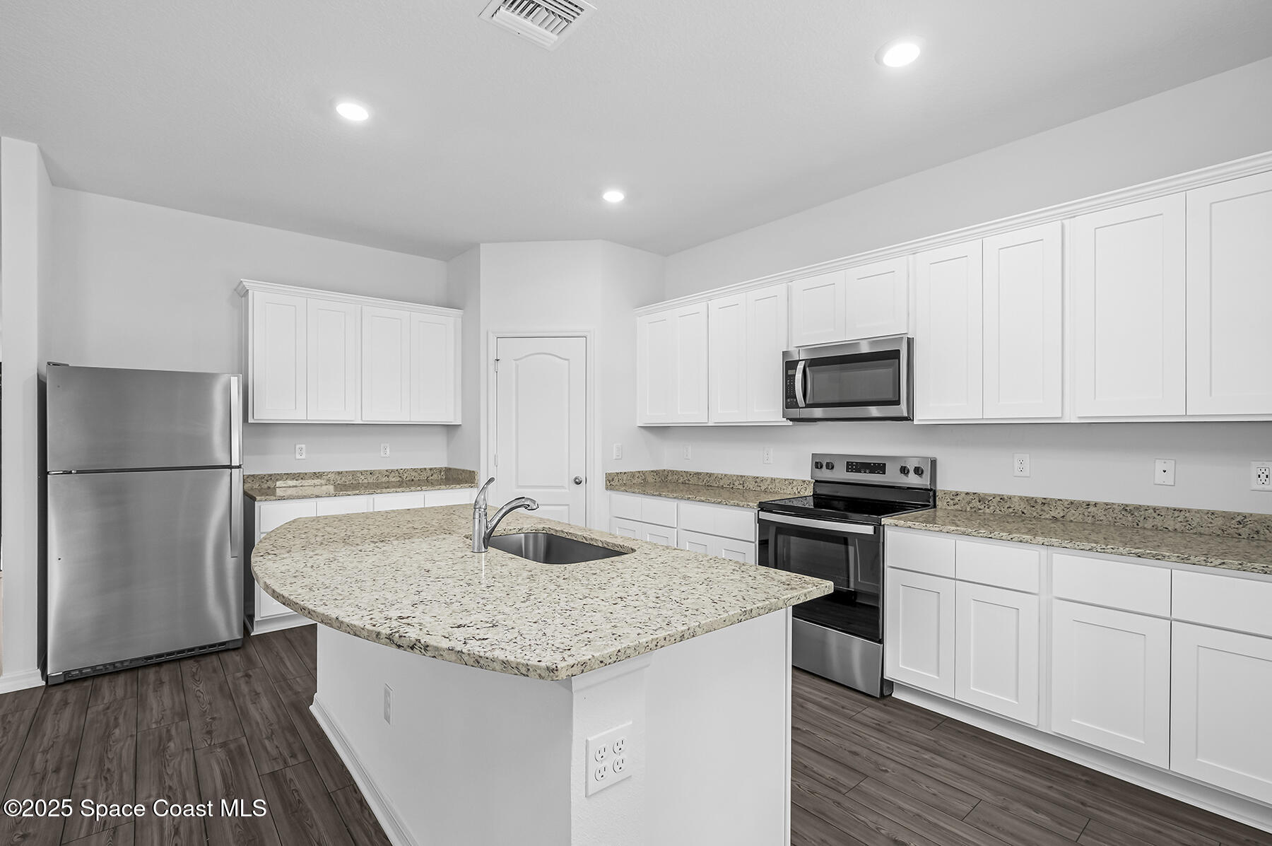 435 Olney Street Palm Bay, FL 32908 - Photo 7 of 18 a kitchen with granite countertop a sink stove and refrigerator