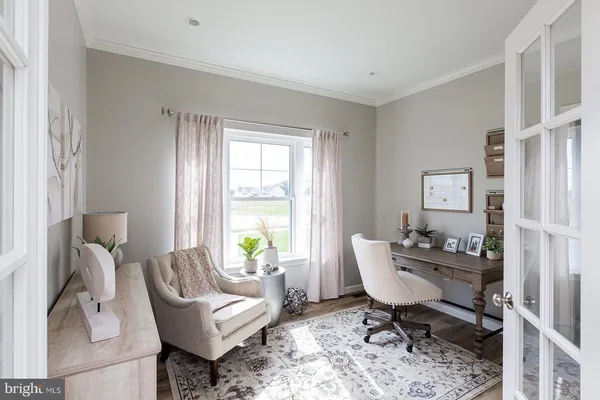a living room with furniture a window and a lamp