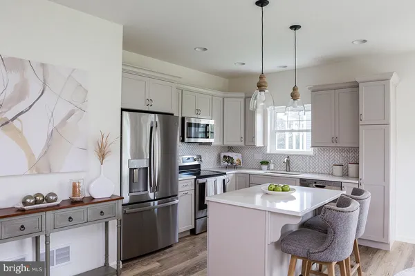 a kitchen with a refrigerator a sink and cabinets