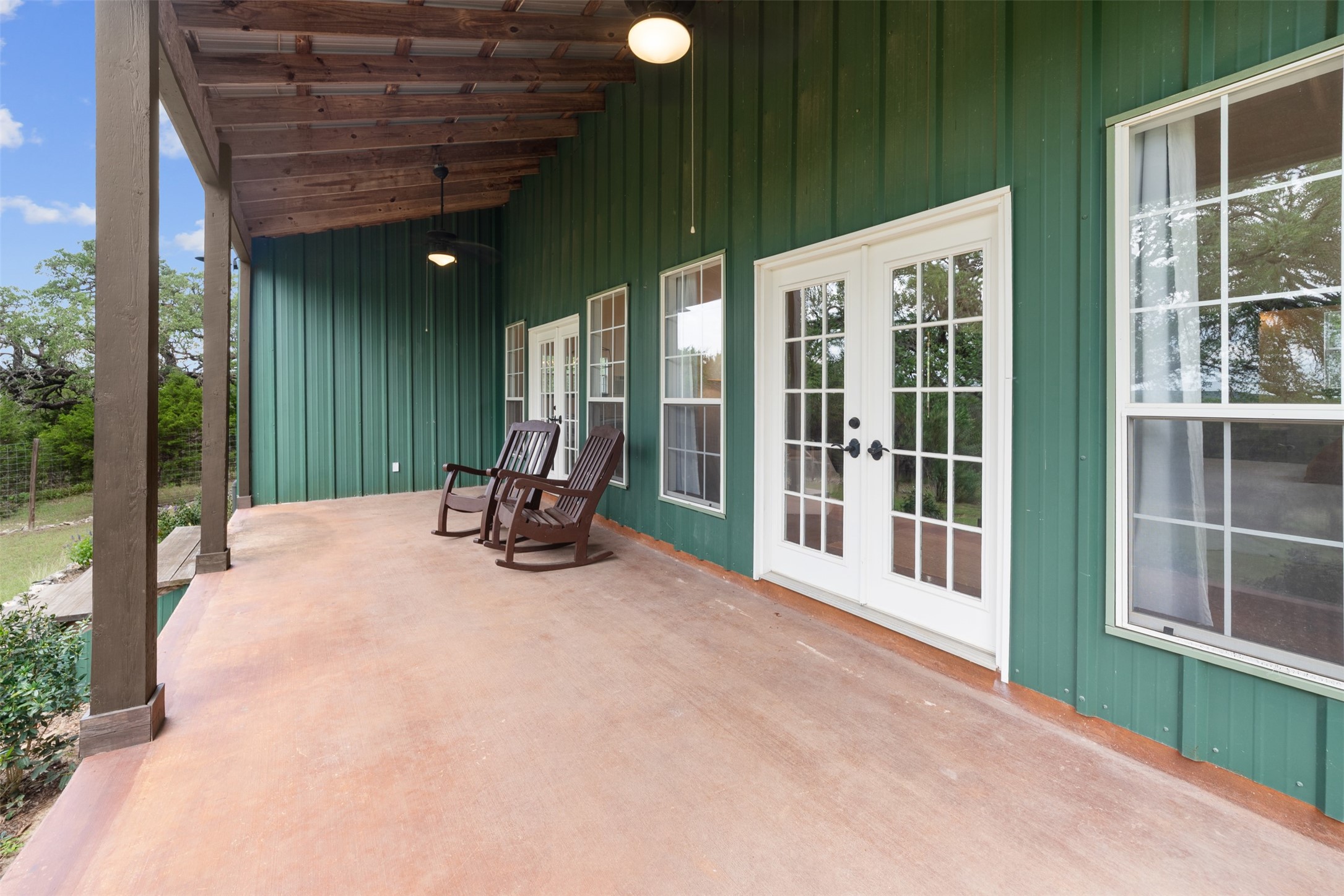34000 Smithson Valley Road Bulverde, TX 78163 - Photo 42 of 50 Relax and enjoy the peaceful countryside from the spacious covered porch featuring French doors and ample room for outdoor seating. A perfect spot for morning coffee or evening sunsets.