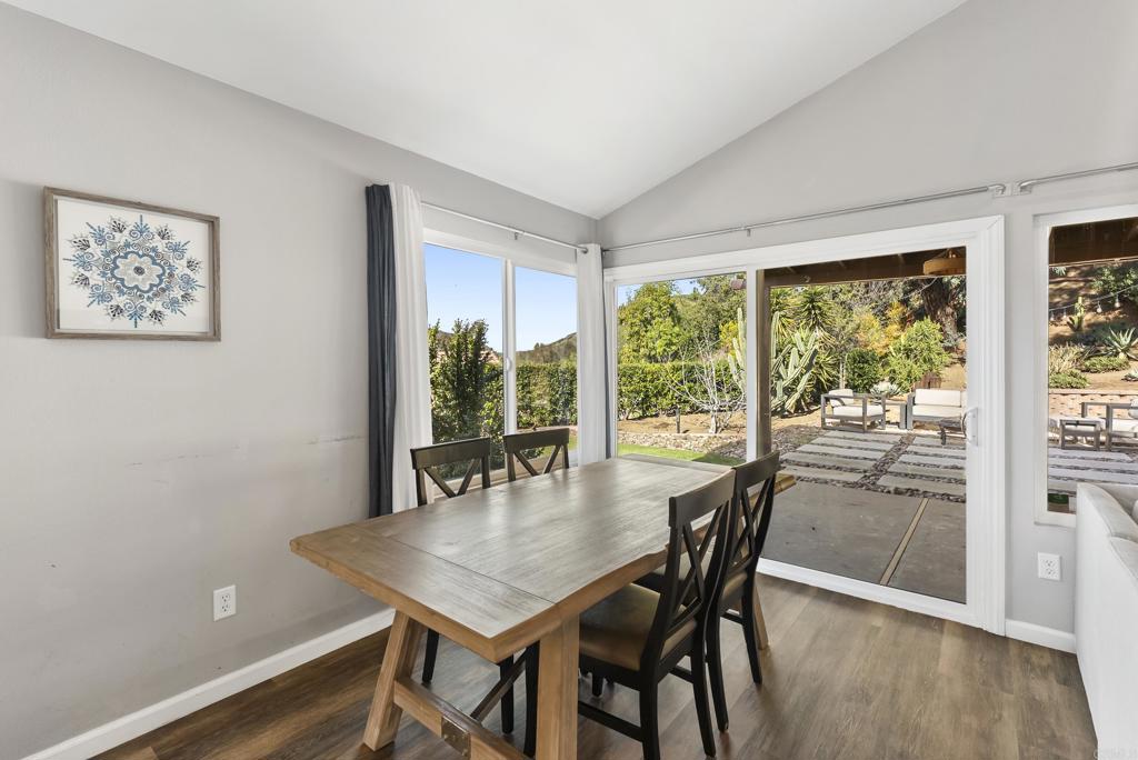 18027 Cotorro Road San Diego, CA 92128 - Photo 11 of 31 a view of a dining room with furniture window and wooden floor