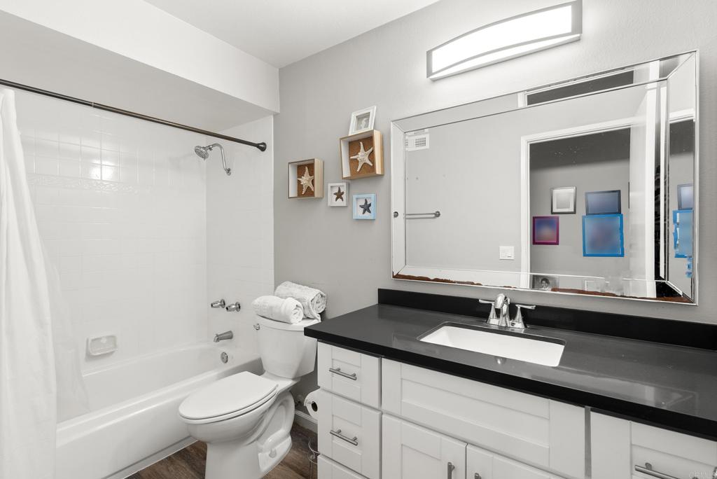 18027 Cotorro Road San Diego, CA 92128 - Photo 14 of 31 a bathroom with a granite countertop sink toilet and shower