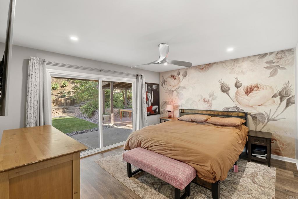 18027 Cotorro Road San Diego, CA 92128 - Photo 17 of 31 a bedroom with a bed and wooden floor