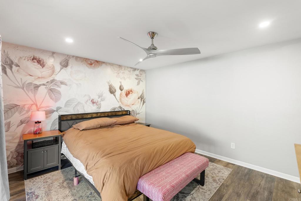 18027 Cotorro Road San Diego, CA 92128 - Photo 18 of 31 a bedroom with a bed and a chandelier