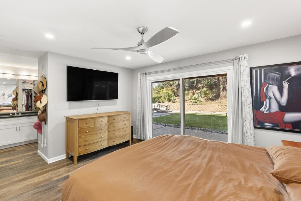 18027 Cotorro Road San Diego, CA 92128 - Photo 19 of 31 a bedroom with a bed and a flat screen tv