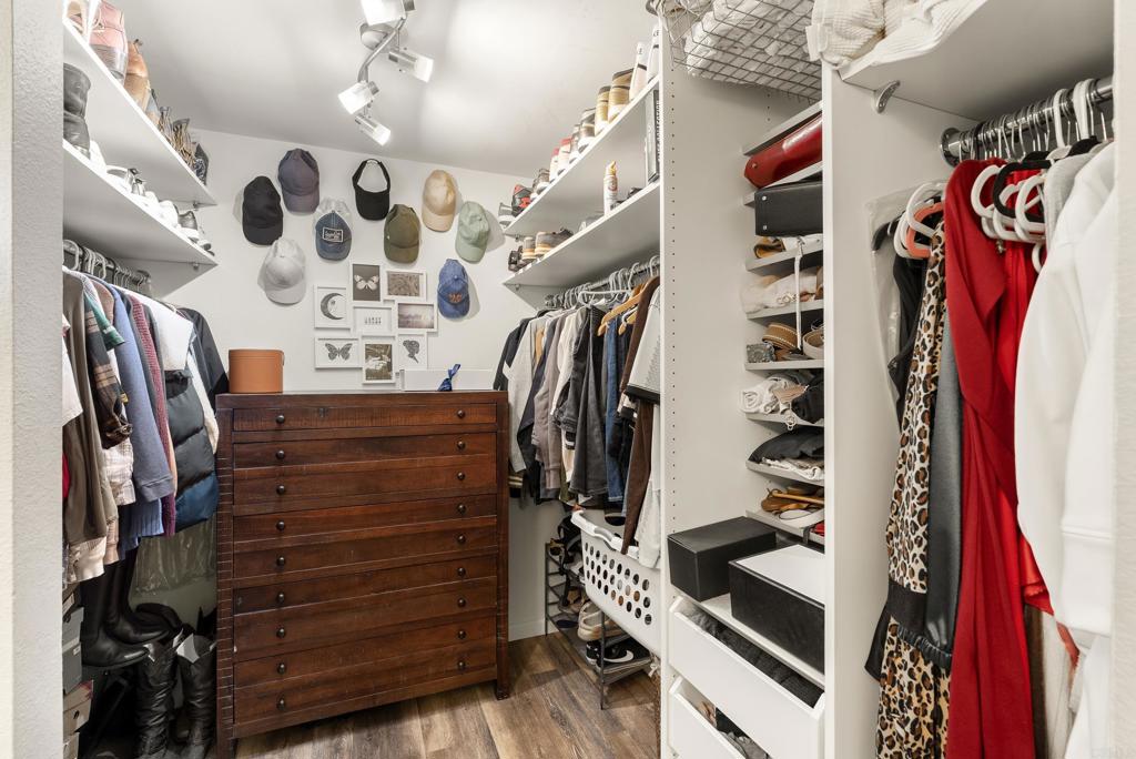 18027 Cotorro Road San Diego, CA 92128 - Photo 21 of 31 a view of walk in closet with clothes and shoes