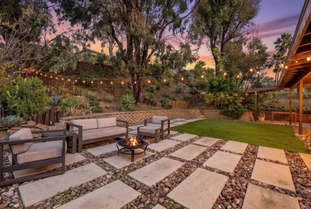 18027 Cotorro Road San Diego, CA 92128 - Photo 25 of 31 a view of a patio with table and chairs potted plants and a large tree