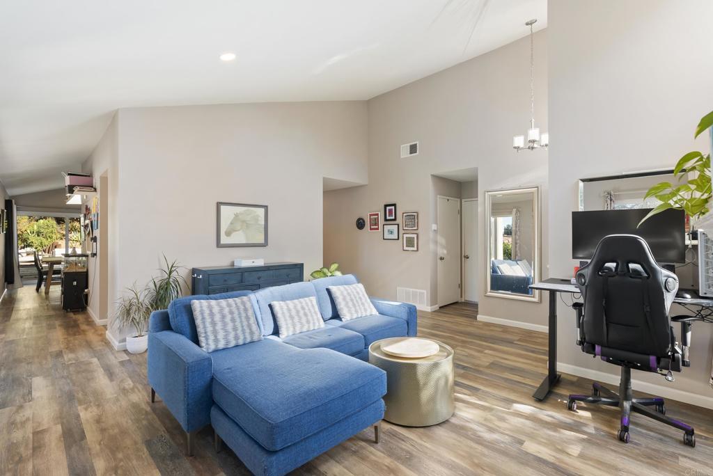18027 Cotorro Road San Diego, CA 92128 - Photo 5 of 31 a living room with furniture a rug and a chandelier