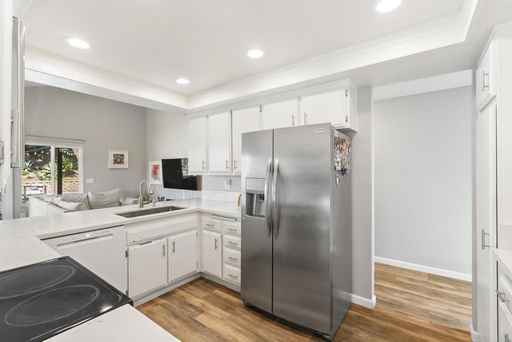18027 Cotorro Road San Diego, CA 92128 - Photo 6 of 31 a kitchen with a sink stainless steel appliances and cabinets