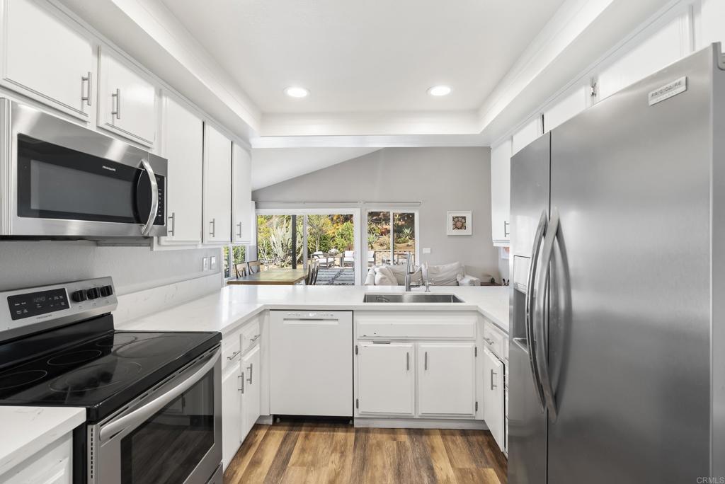 18027 Cotorro Road San Diego, CA 92128 - Photo 7 of 31 a kitchen with a sink stove and microwave