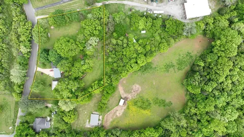 a view of a house with backyard sitting area and garden