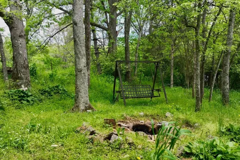 a view of a house with a yard and sitting area