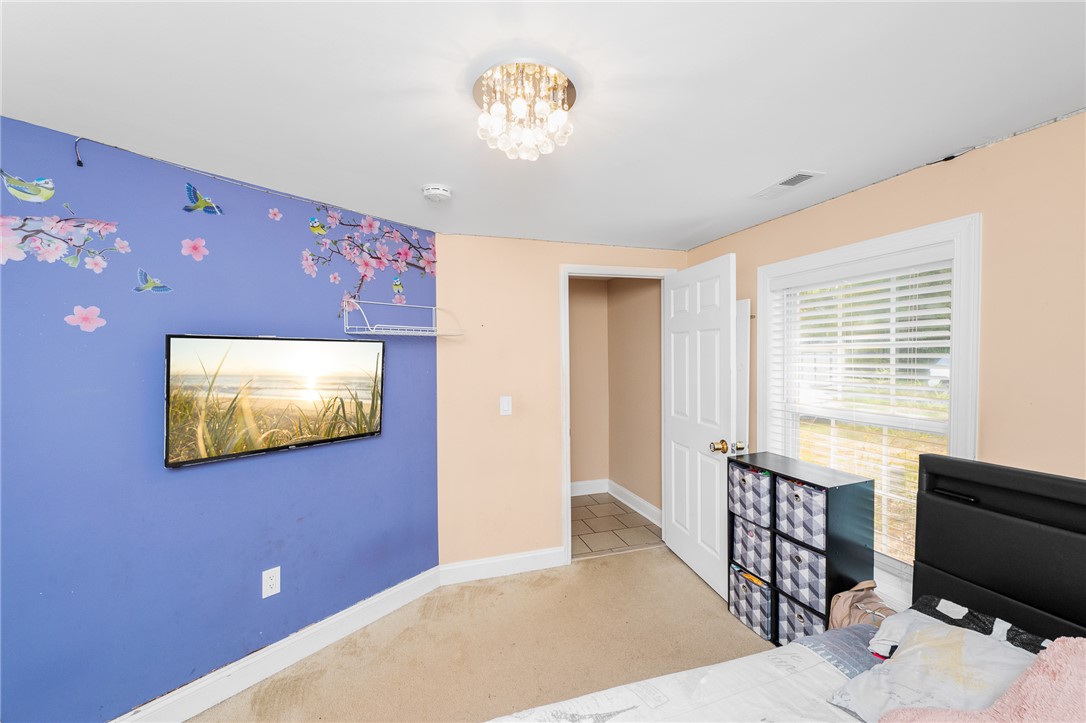 358 Finley Road Easley, SC 29642 - Photo 11 of 20 This cozy bedroom features warm lighting and a charming window, creating an inviting personal space.