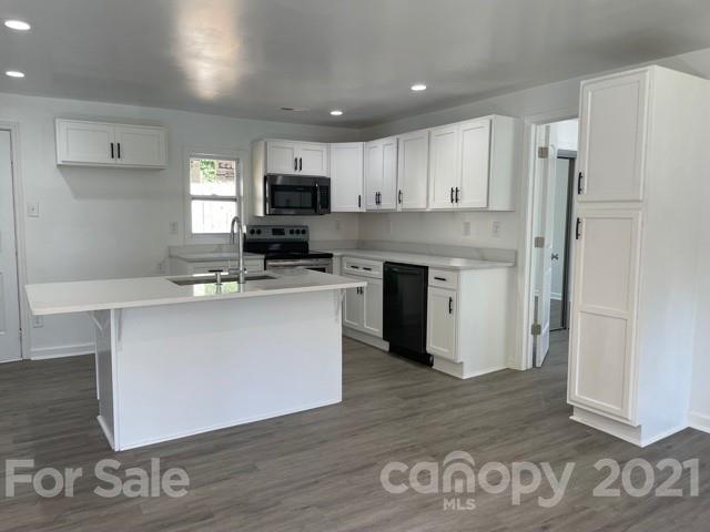 315 South Ransom Street Gastonia, NC 28052 - Photo 2 of 20 a kitchen with a sink cabinets and wooden floor