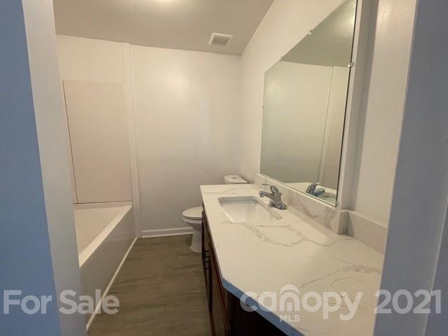 315 South Ransom Street Gastonia, NC 28052 - Photo 14 of 20 a bathroom with a sink and a mirror