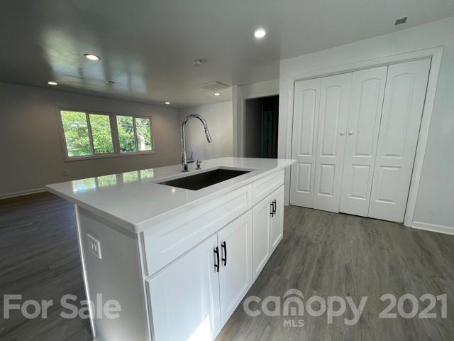 315 South Ransom Street Gastonia, NC 28052 - Photo 3 of 20 a kitchen that has a sink and a stove in it