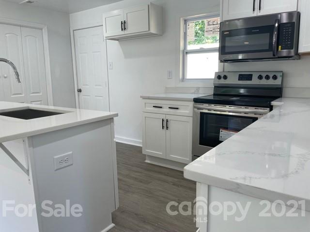 315 South Ransom Street Gastonia, NC 28052 - Photo 4 of 20 a kitchen with stainless steel appliances granite countertop a sink stove and microwave