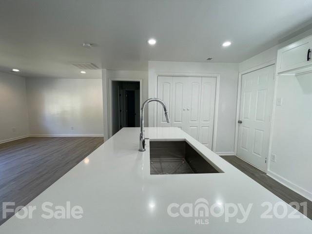 315 South Ransom Street Gastonia, NC 28052 - Photo 7 of 20 a kitchen with a sink and a stove top oven