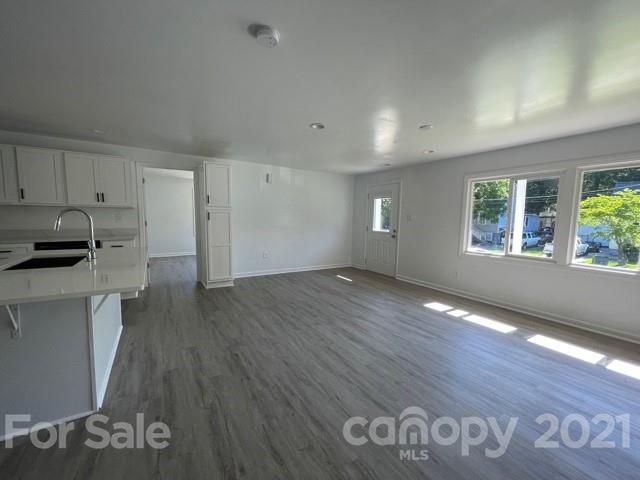315 South Ransom Street Gastonia, NC 28052 - Photo 9 of 20 a view of empty room with wooden floor and fan