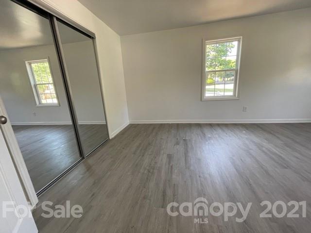 315 South Ransom Street Gastonia, NC 28052 - Photo 10 of 20 an empty room with wooden floor and windows