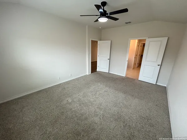 a view of a big room with wooden floor and windows in a room