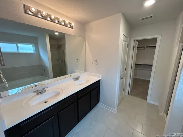 a bathroom with a double vanity sink and mirror