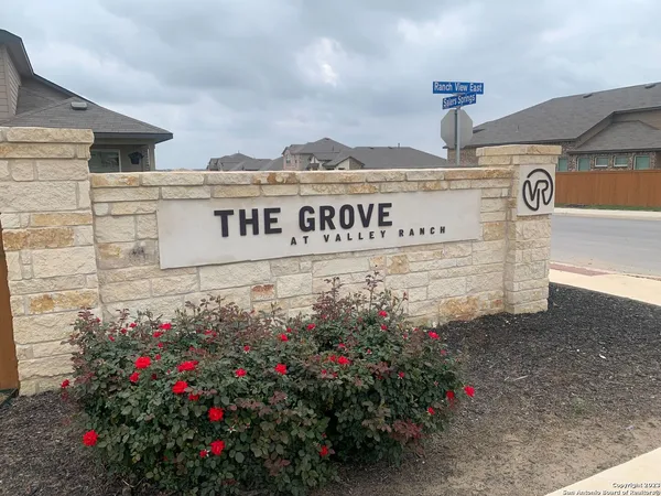 a sign that is in front of flowers