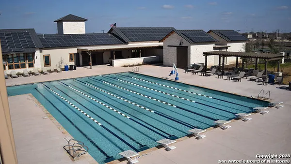 a view of a swimming pool with a outdoor seating