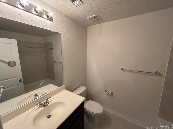 a bathroom with a sink toilet and vanity