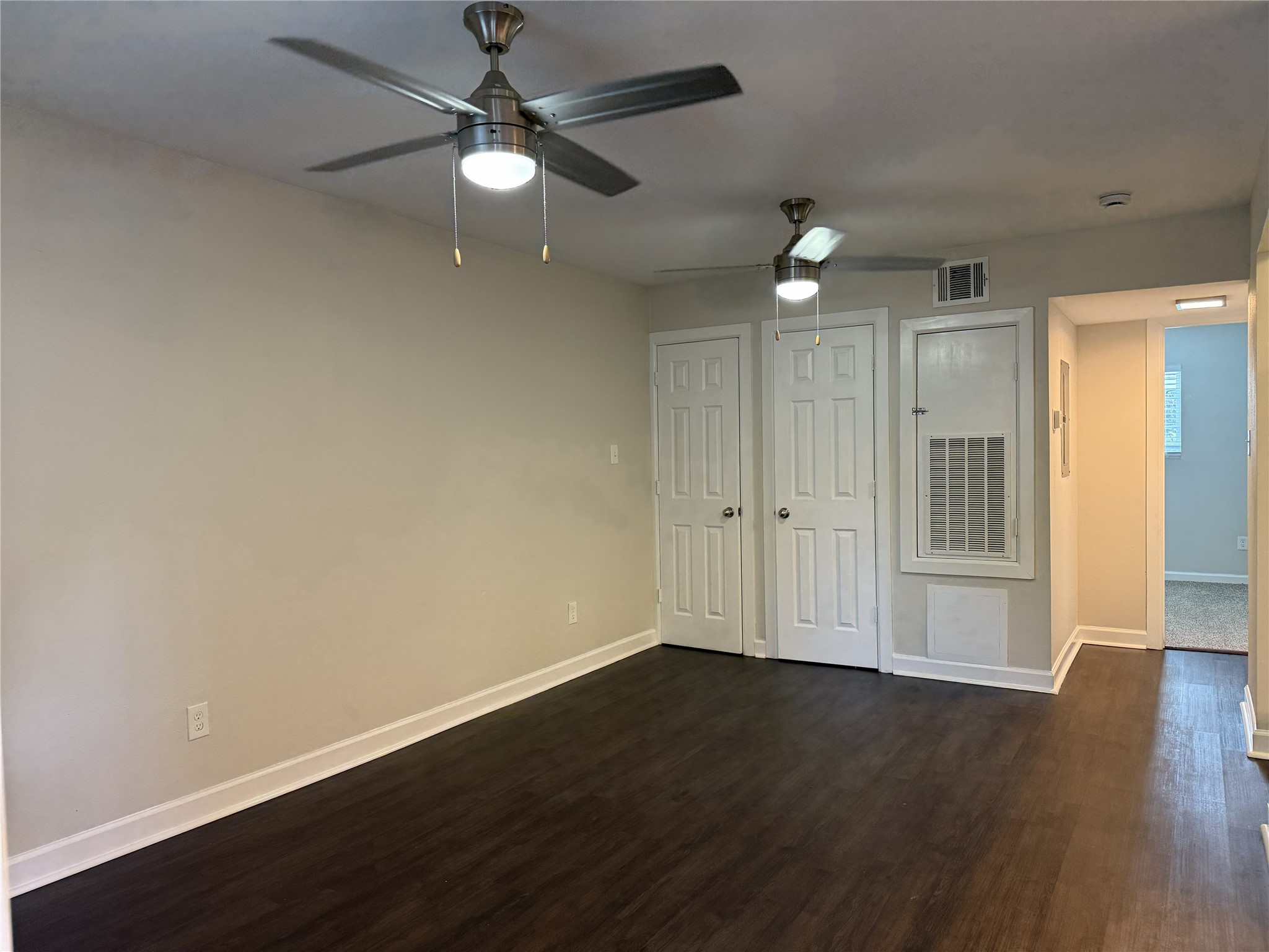 1824 Thonig Road, Unit 10 Houston, TX 77055 - Photo 2 of 17 an empty room with wooden floor ceiling fan and window