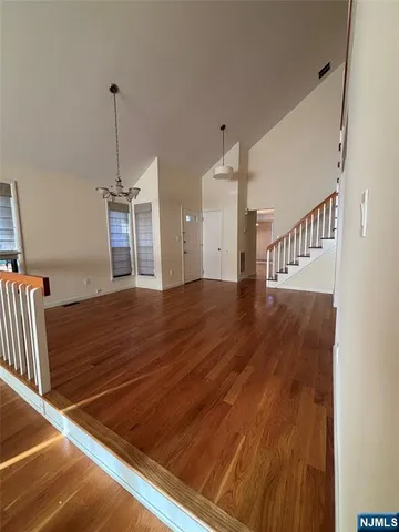 a view of a room with wooden floor