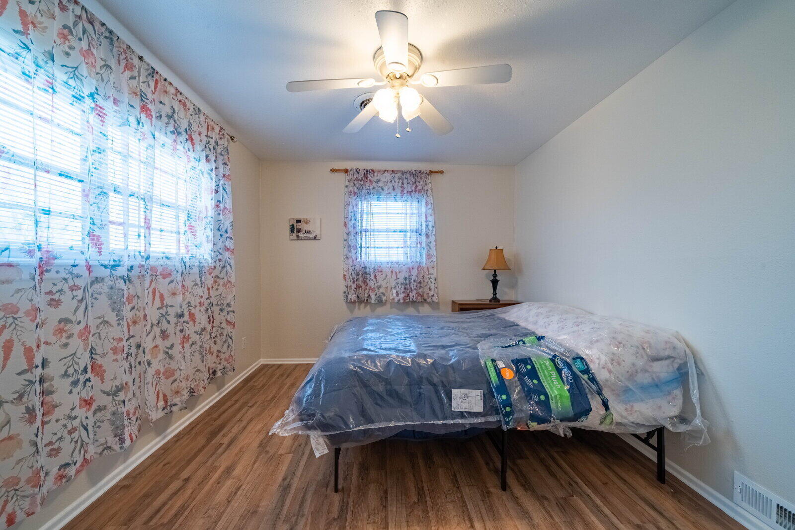 5202 47th Street Lubbock, TX 79414 - Photo 7 of 15 a bedroom with a bed and wooden floor