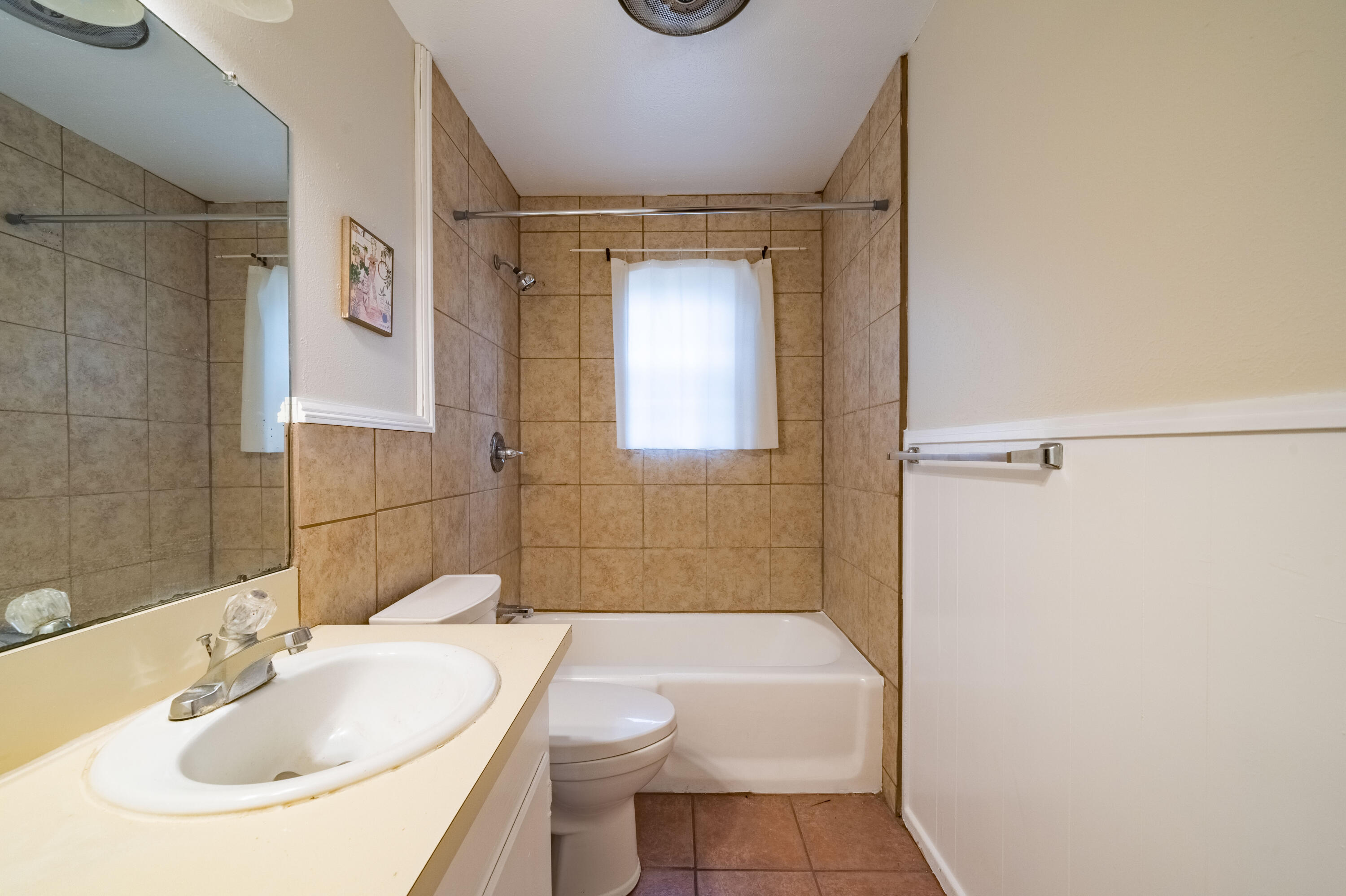 5202 47th Street Lubbock, TX 79414 - Photo 9 of 15 a bathroom with a sink a toilet and shower