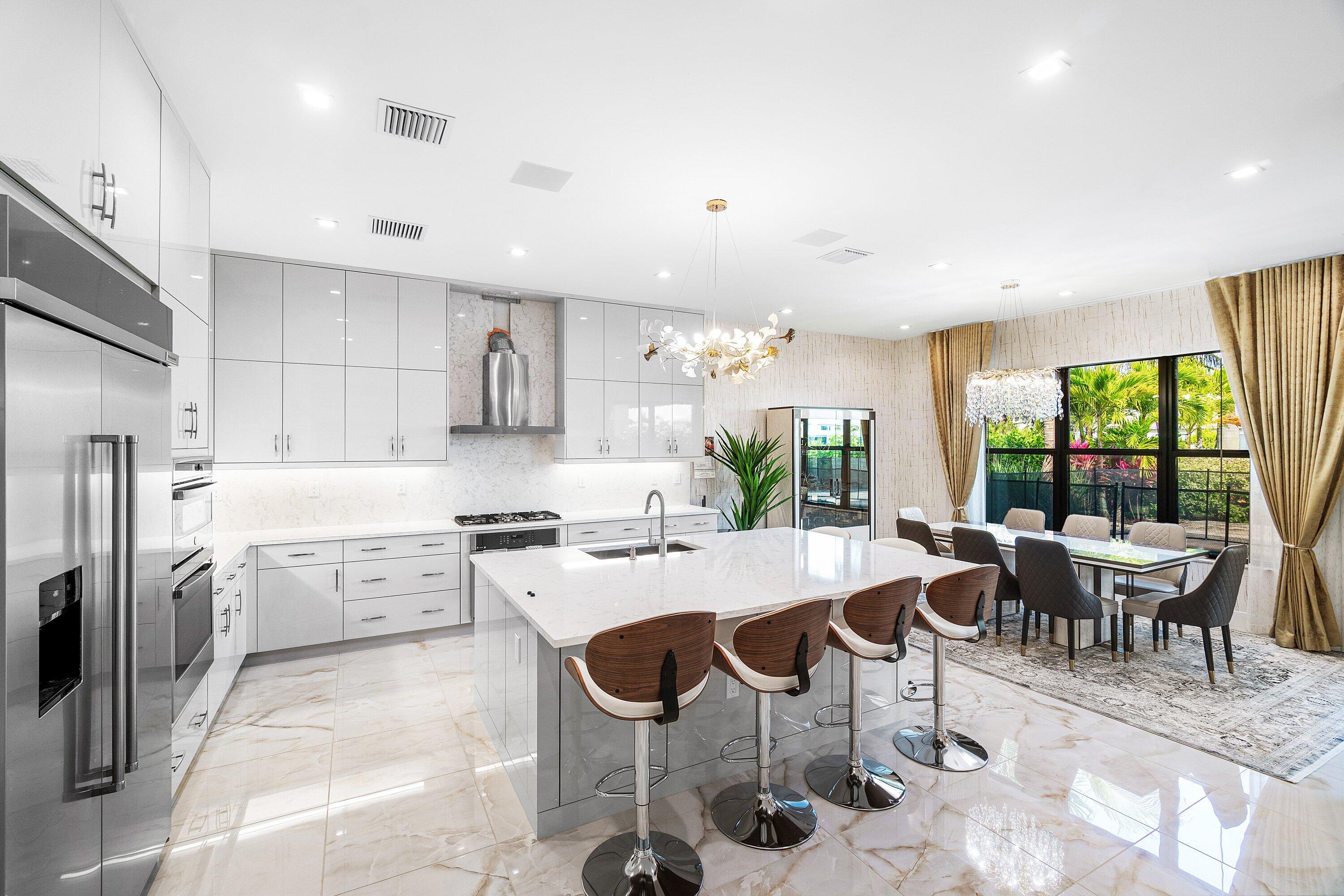 8233 Crystal Downs Avenue Boca Raton, FL 33434 - Photo 15 of 58 a large kitchen with a table and chairs