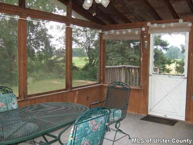 607 Old Rte 32, Unit LANE OFF OLD ROUTE 32 New Paltz, NY 12561 - Photo 2 of 6 a patio with yard glass top table and chairs