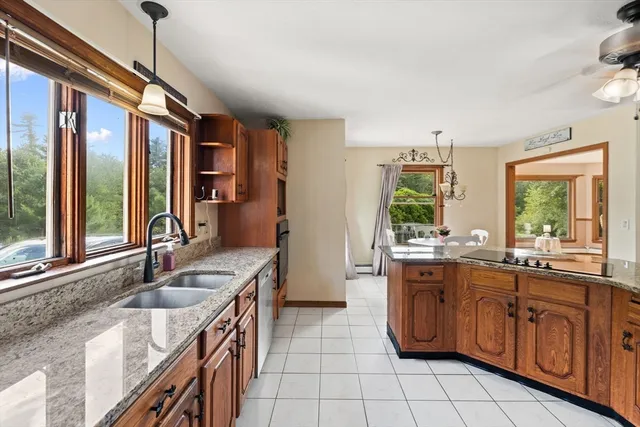 a kitchen with stainless steel appliances granite countertop a sink and a stove