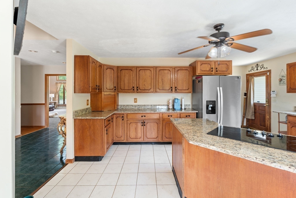 103 Renshaw Road Weare, NH 03281 - Photo 12 of 42 a kitchen with stainless steel appliances granite countertop a refrigerator a sink and a stove