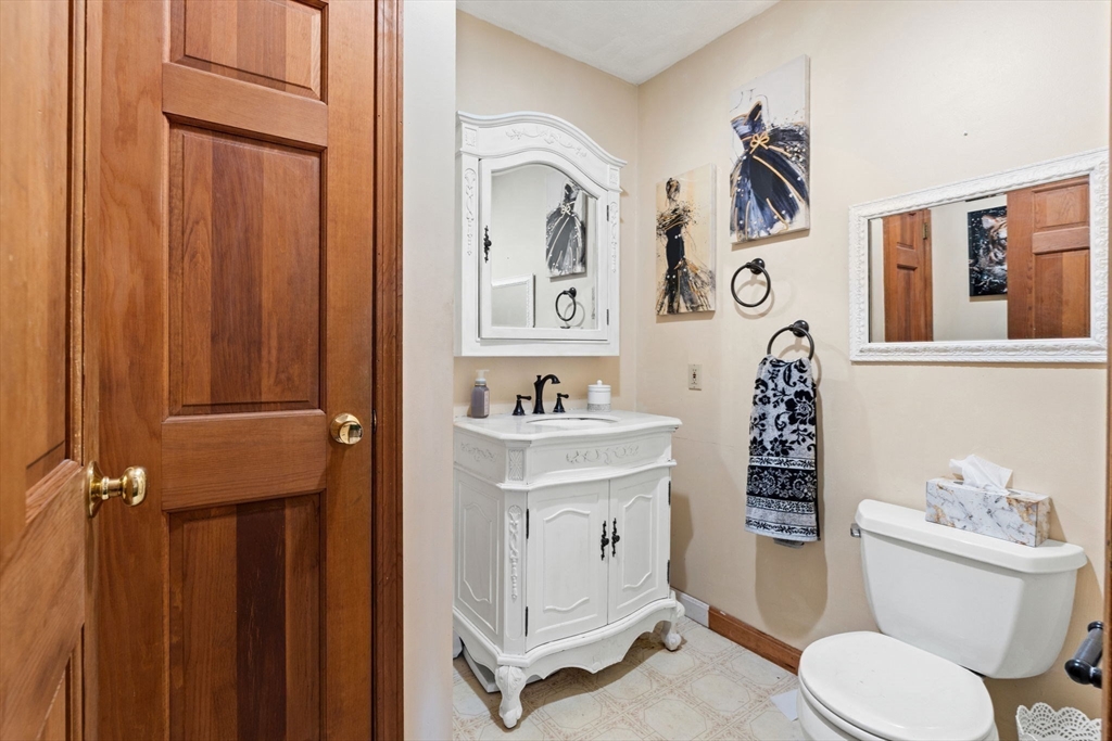 103 Renshaw Road Weare, NH 03281 - Photo 16 of 42 a bathroom with a sink a mirror a toilet and a shower