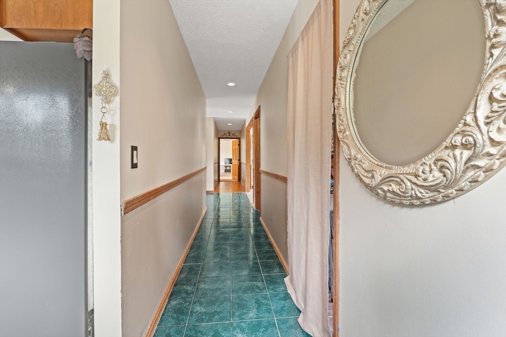 103 Renshaw Road Weare, NH 03281 - Photo 17 of 42 a view of a hallway with wooden floor and entryway