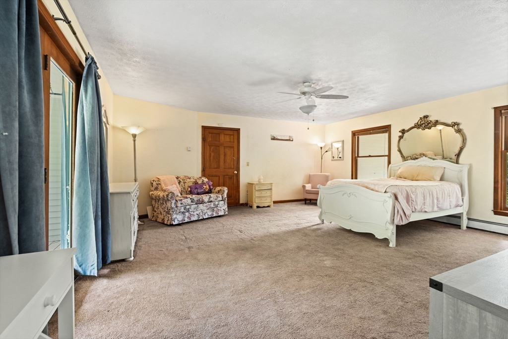 103 Renshaw Road Weare, NH 03281 - Photo 18 of 42 a spacious bedroom with a bed and a couch
