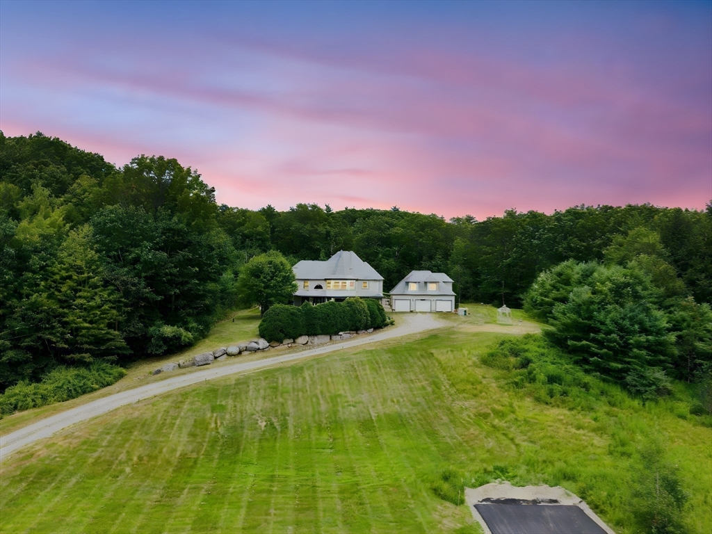 103 Renshaw Road Weare, NH 03281 - Photo 2 of 42 a view of a garden with a building in the background