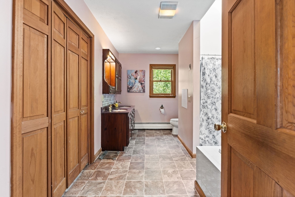 103 Renshaw Road Weare, NH 03281 - Photo 22 of 42 a view of a hallway and a livingroom with furniture