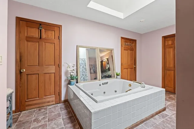a white bath tub sitting in a en suite bathroom